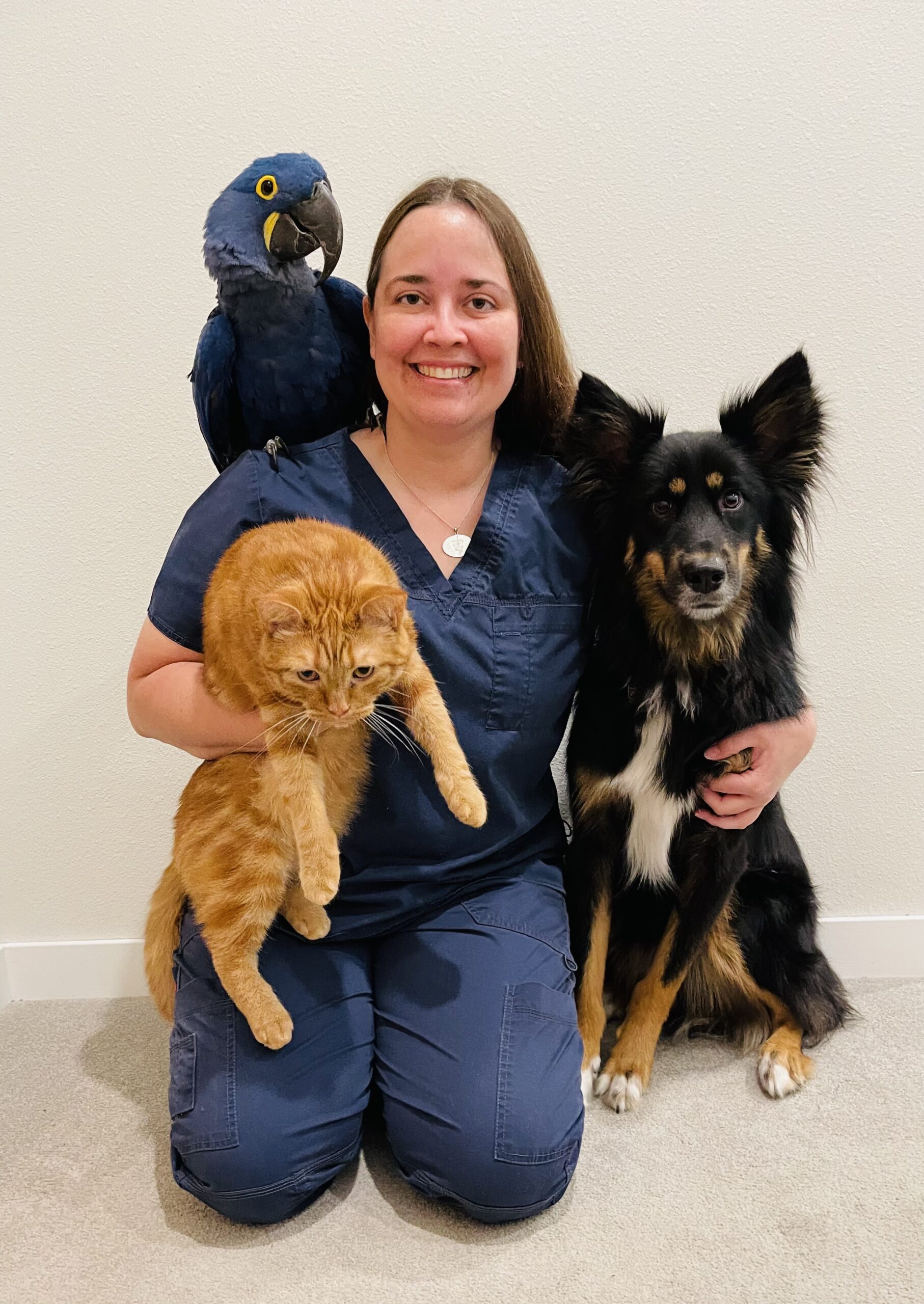Dr. Jones with her bird, cat, and dog